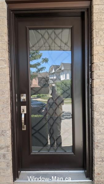 Brown front door. Oak Ridge wrought iron glass insert